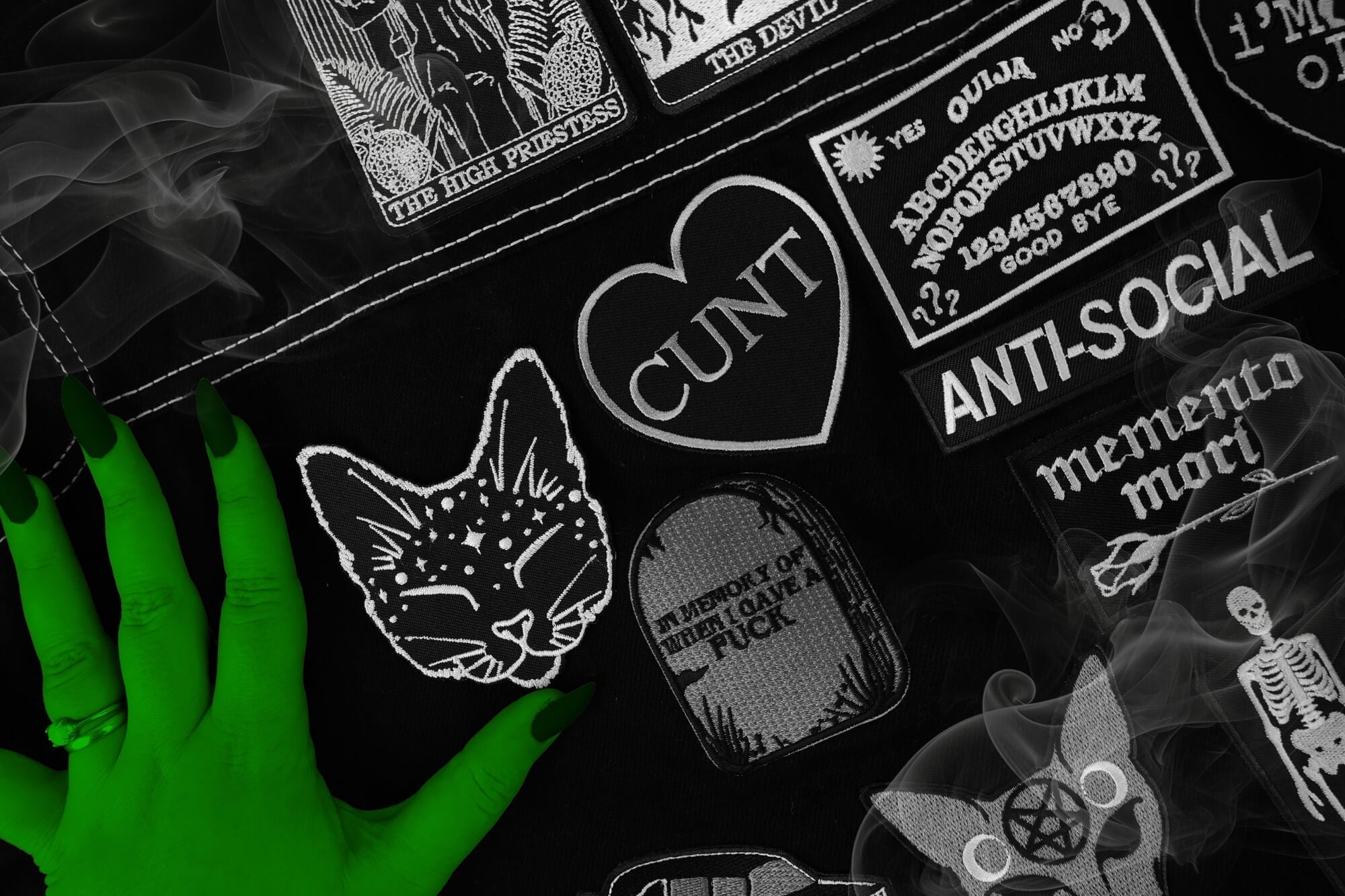 Collection of dark-themed patches with various designs on a black background.